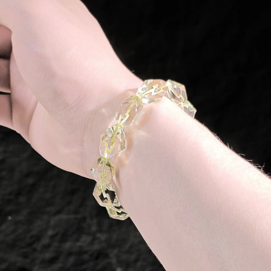 Lemon yellow citrine faceted bracelet worn on wrist; warm glow and subtle sparkle visible under natural light