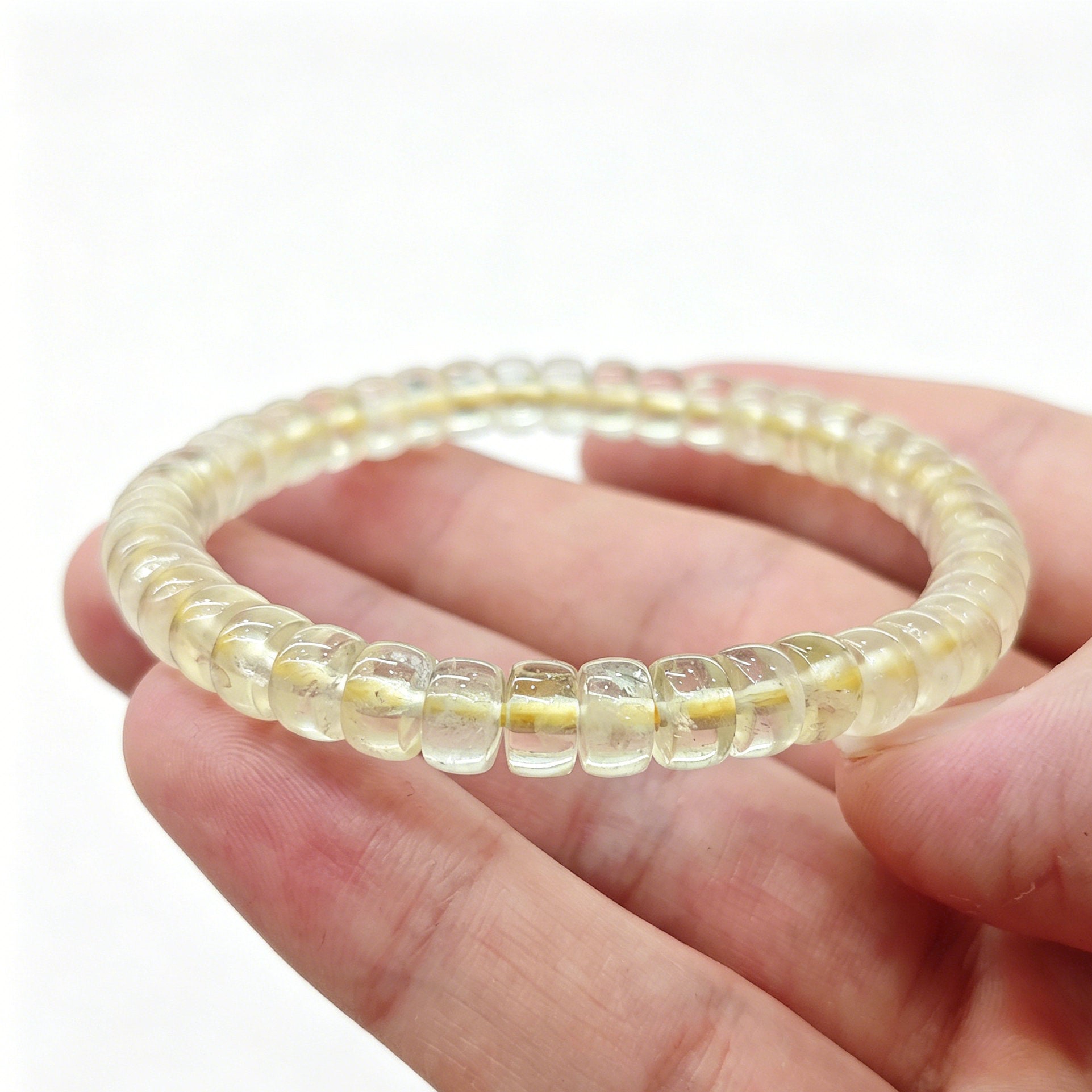 Close-up of mini lemon citrine tablet bracelet held in hand—showing high translucency and smooth polished edges