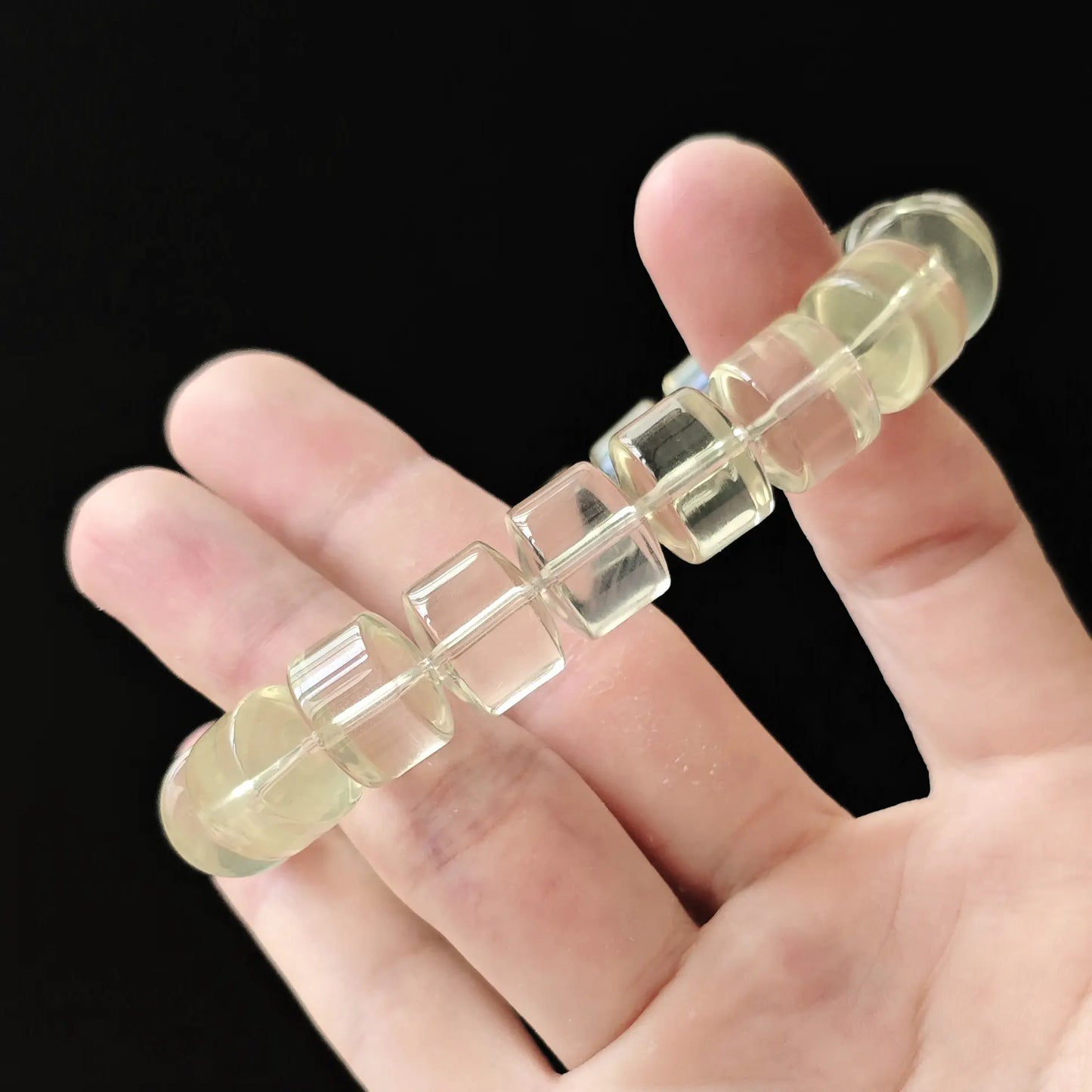 Citrine wheel bracelet stretched between fingers—showing durable elastic cord, secure knotting, and consistent bead spacing