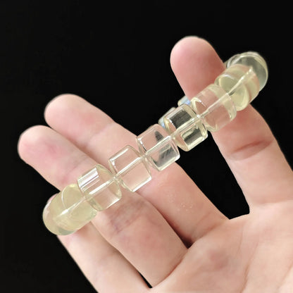 Citrine wheel bracelet stretched between fingers—showing durable elastic cord, secure knotting, and consistent bead spacing