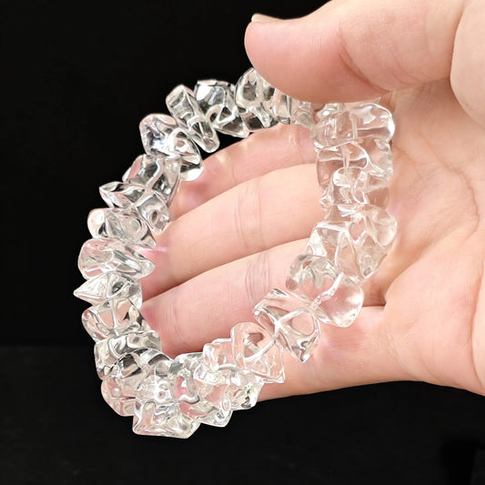 Video thumbnail: natural clear crystal bracelet rotating in hand, showcasing dynamic light refraction through irregular facets—ideal for chakra alignment practice