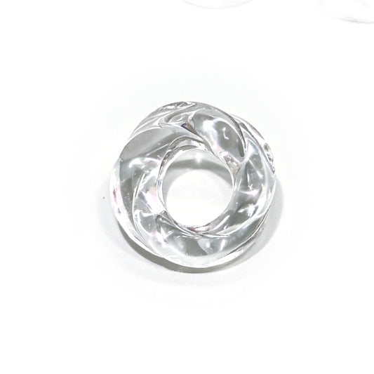 Natural clear quartz Möbius ring pendant on white background, translucent with hand-carved continuous loop design