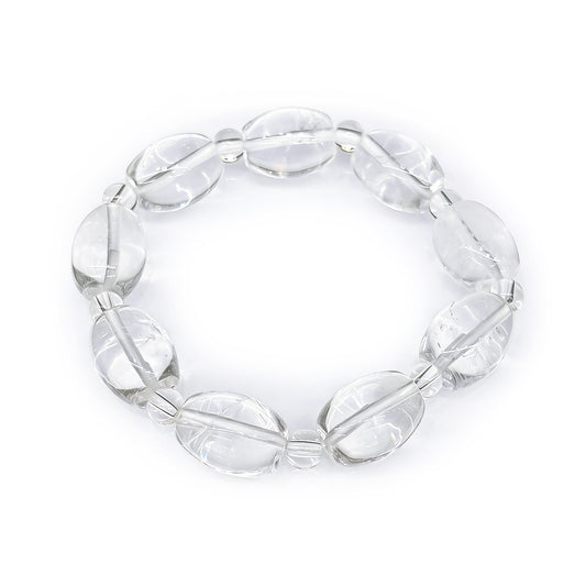 Natural clear quartz oval drum bead bracelet on white background, sugar bean shaped crystal beads, minimalist spiritual jewelry