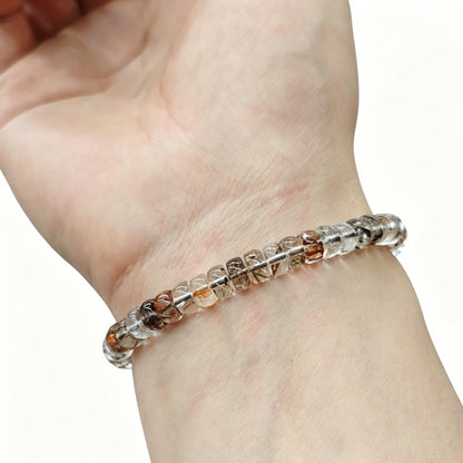 Clear quartz tablet beads with natural internal inclusions—6×3mm size, stretch elastic, worn on wrist