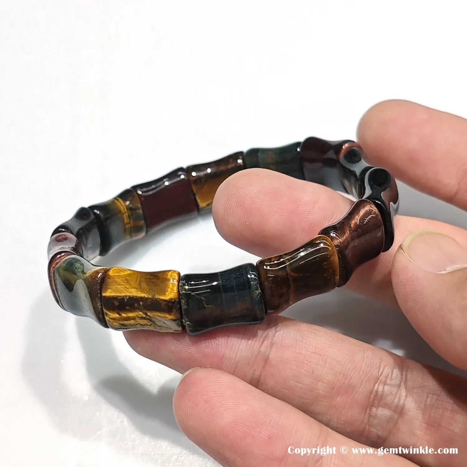 Side view of bamboo-style tiger eye bracelet highlighting joint details between 15mm bead units and natural color transitions (yellow → blue → red)