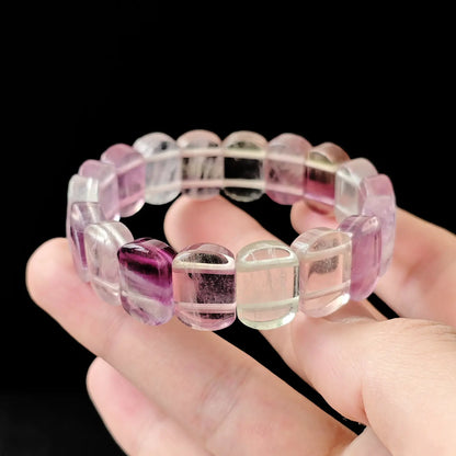 Close-up of natural fluorite oval beads with visible color zoning and polished facets, highlighting transparency and crystalline structure