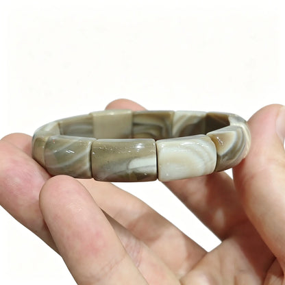 Detailed view: picture jasper bead showing smooth polished surface and organic layered patterns under soft light