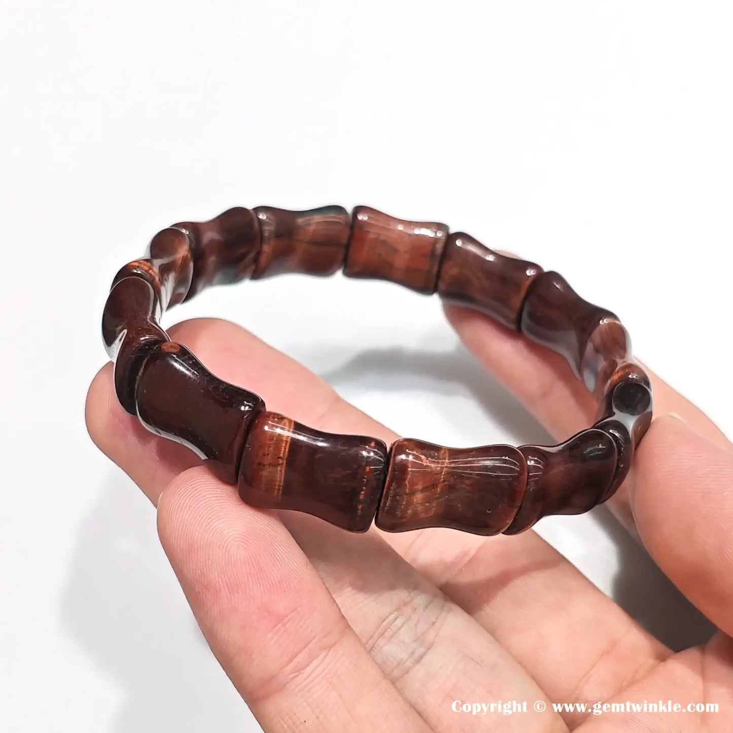 Side view showing smooth joints between 15mm red tiger eye bamboo segments, with polished ridges and natural banding — ideal for retail detail shots