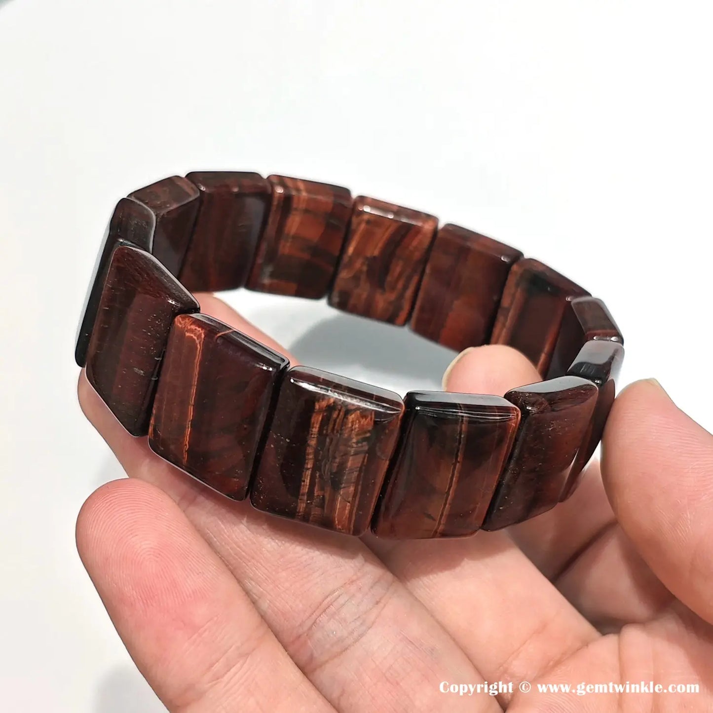 Side view showing sharp rectangular edges of red tiger eye beads (20mm length), polished surfaces, and natural banding — ideal for retail detail shots