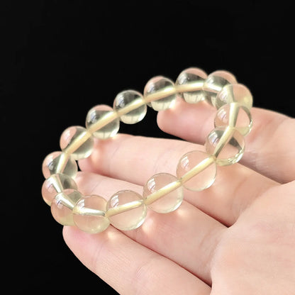 Macro: single citrine round bead with flawless surface, no cotton or cloudiness, bright lemon-yellow under studio light