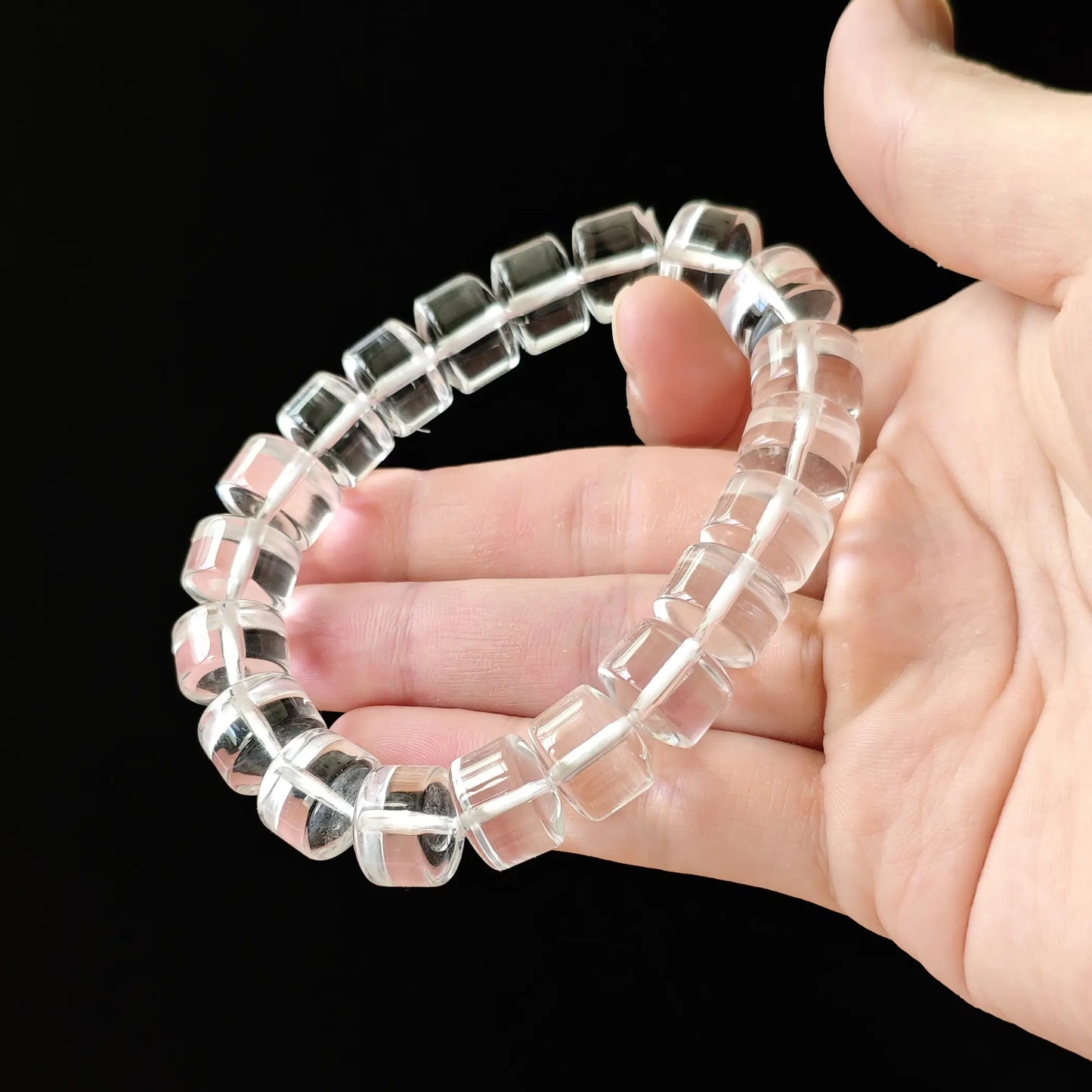 Macro: single clear quartz rondelle bead with smooth beveled edges, no cloudiness or inclusions, water-like transparency