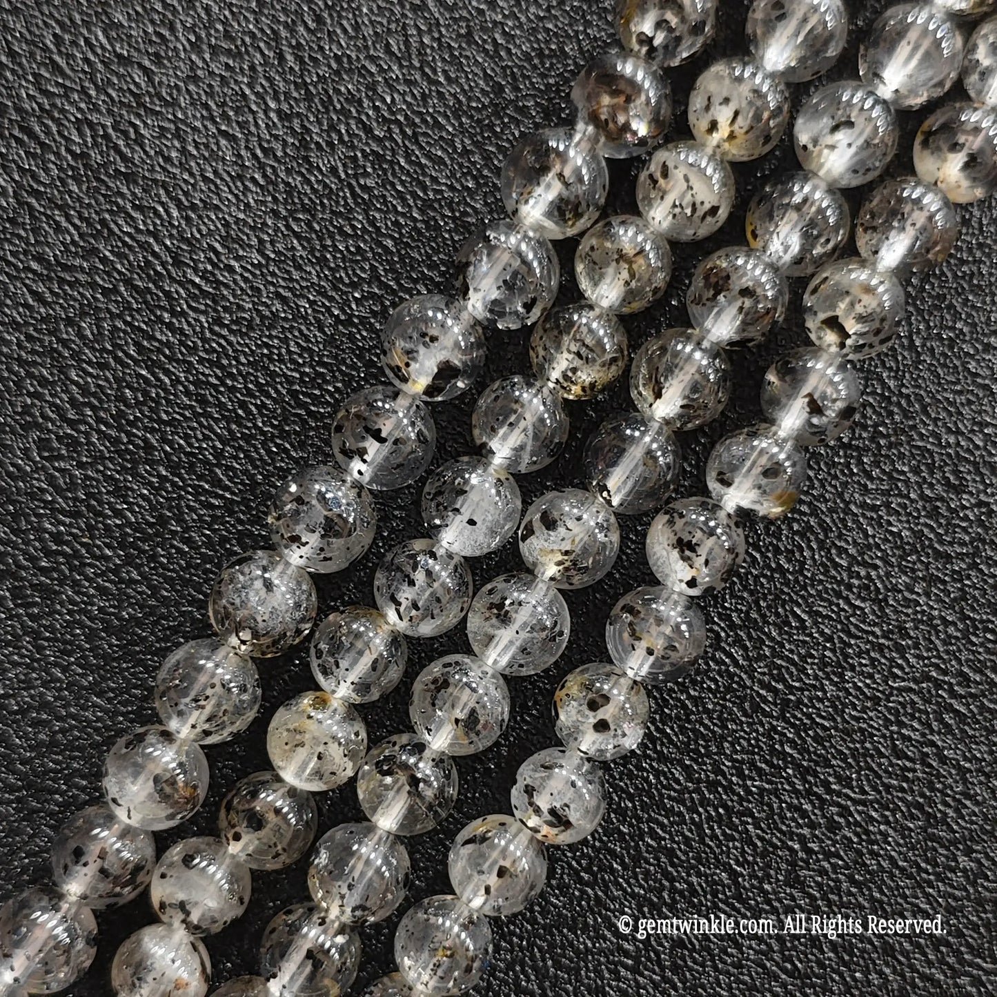 Close up view of black mica inclusion quartz strands from image_1fa6d4.jpg displaying distinct speckles