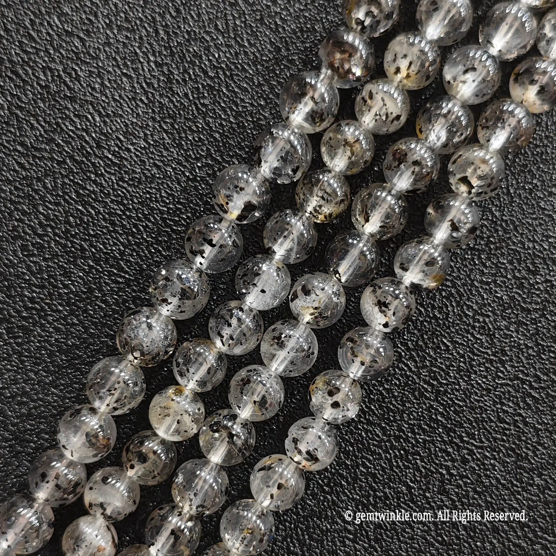 Close up view of black mica inclusion quartz strands from image_1fa6d4.jpg displaying distinct speckles