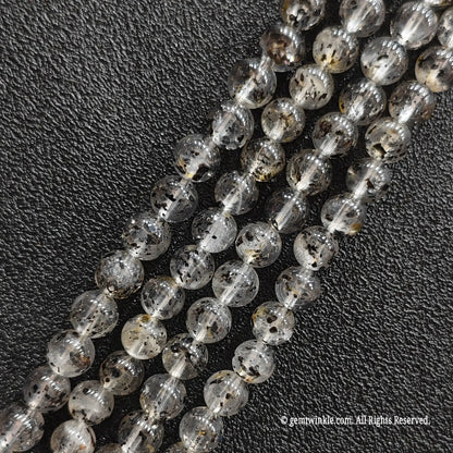 Close up view of black mica inclusion quartz strands from image_1fa6d4.jpg displaying distinct speckles