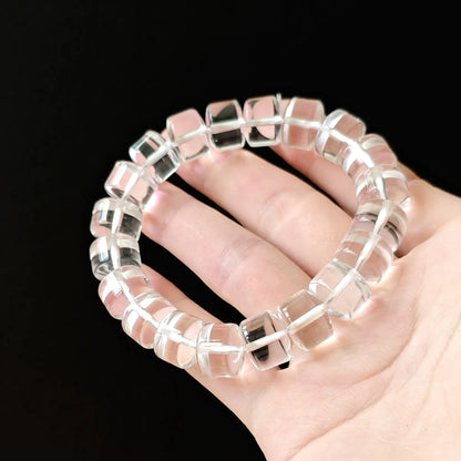 Clear quartz rondelle beads gently curved—demonstrating stretch comfort, even spacing, and light refraction through polished surfaces