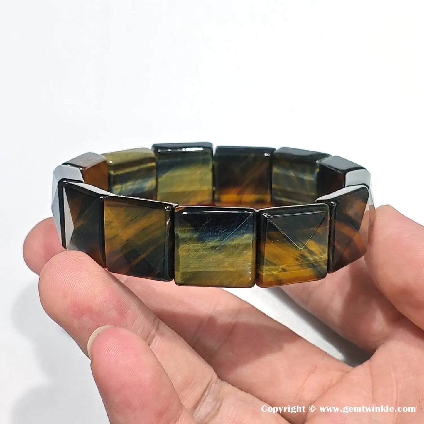 Close-up showing the solid structure and sharp geometric cut of the ~16mm blue-gold tiger eye beads, crafted for a masculine aesthetic.