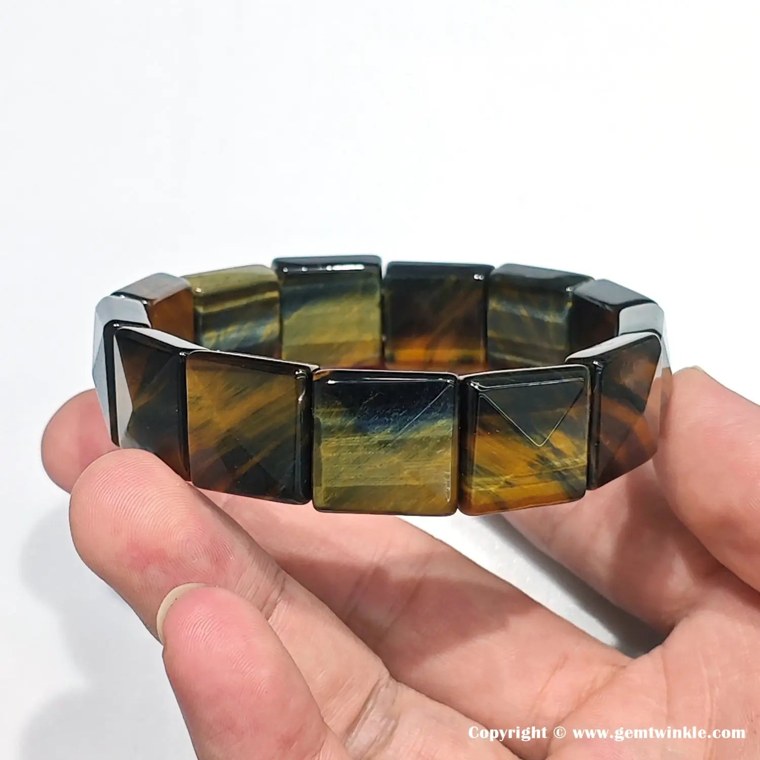 Close-up showing the solid structure and sharp geometric cut of the ~16mm blue-gold tiger eye beads, crafted for a masculine aesthetic.