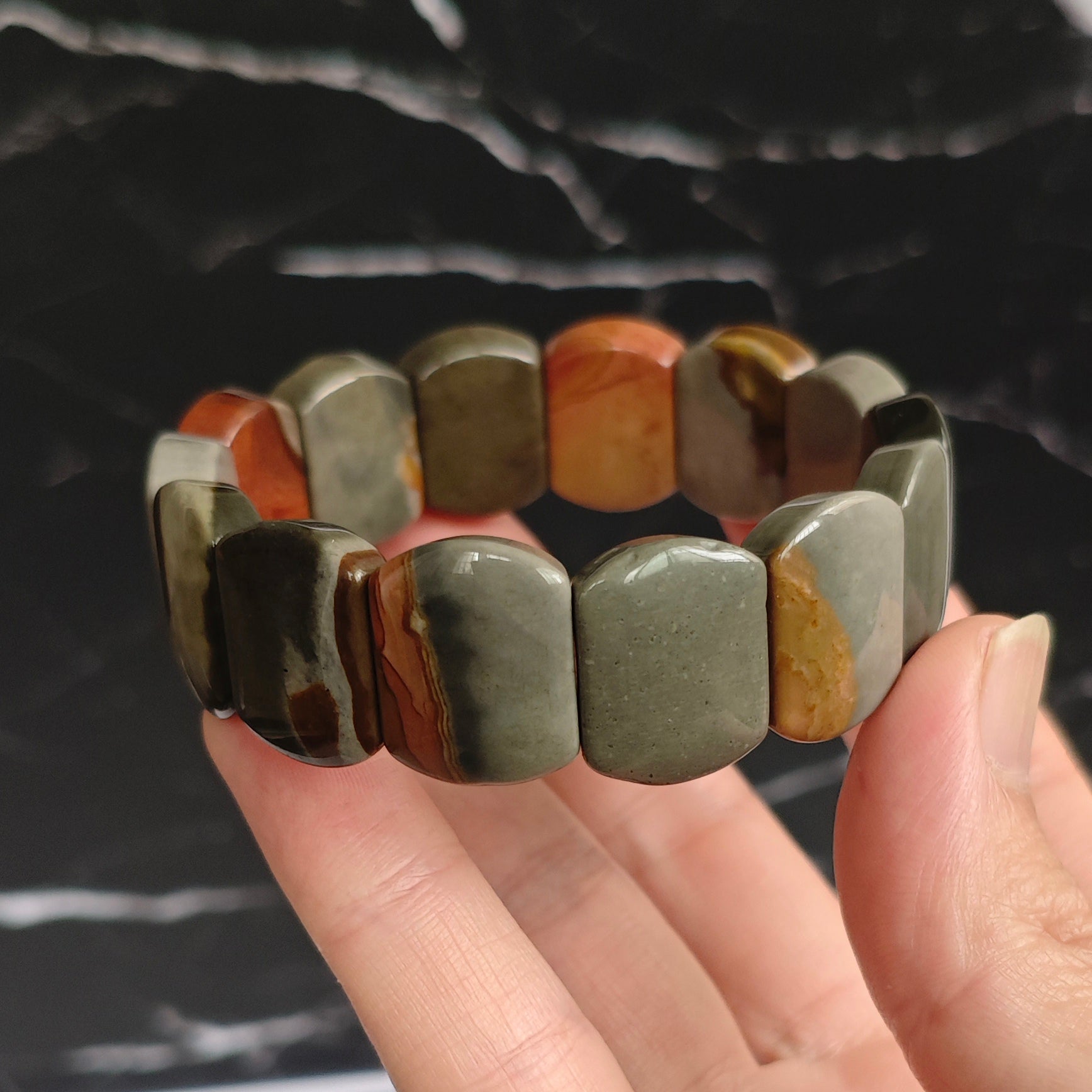 Side view of ocean jasper bead: distinct concentric rings and subtle color gradients in natural stone