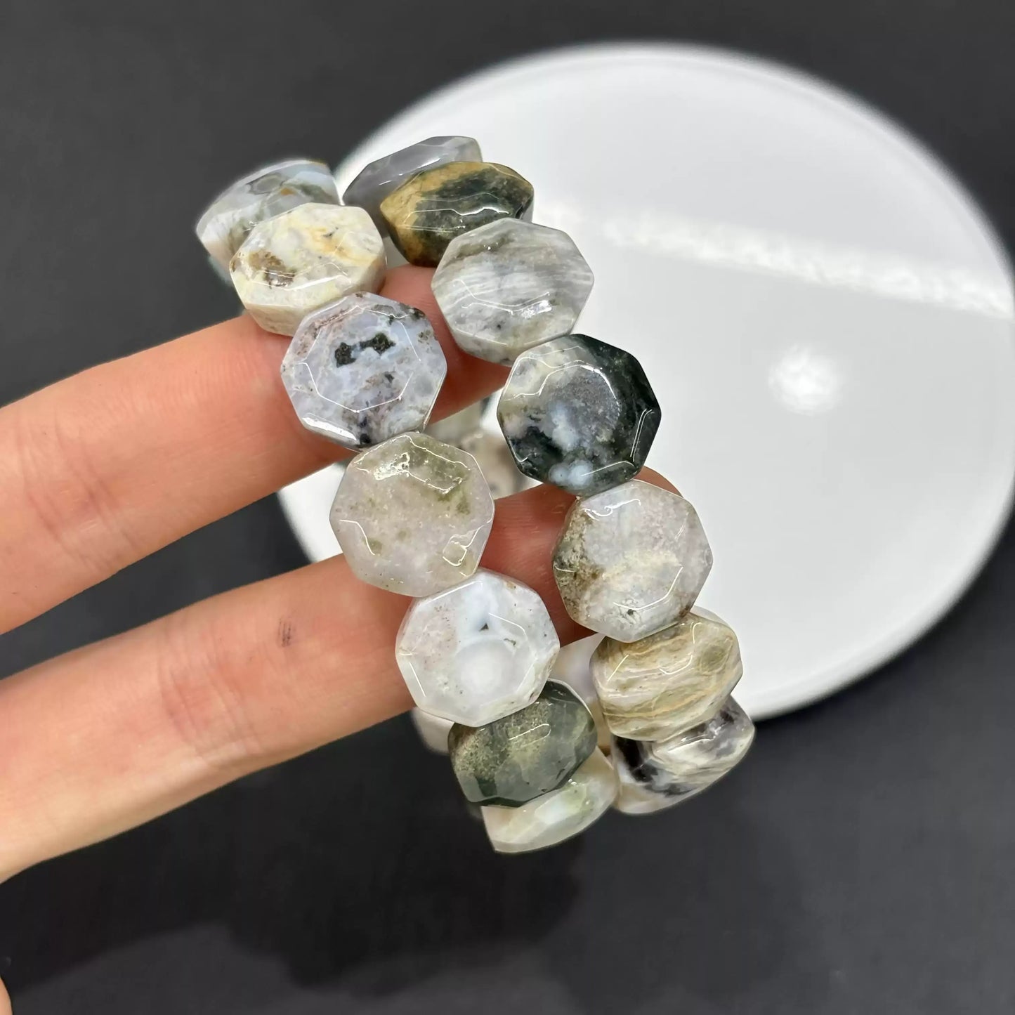 Close-up of natural Ocean Jasper’s orbicular patterns and faceted surfaces—each bead unique due to geological formation