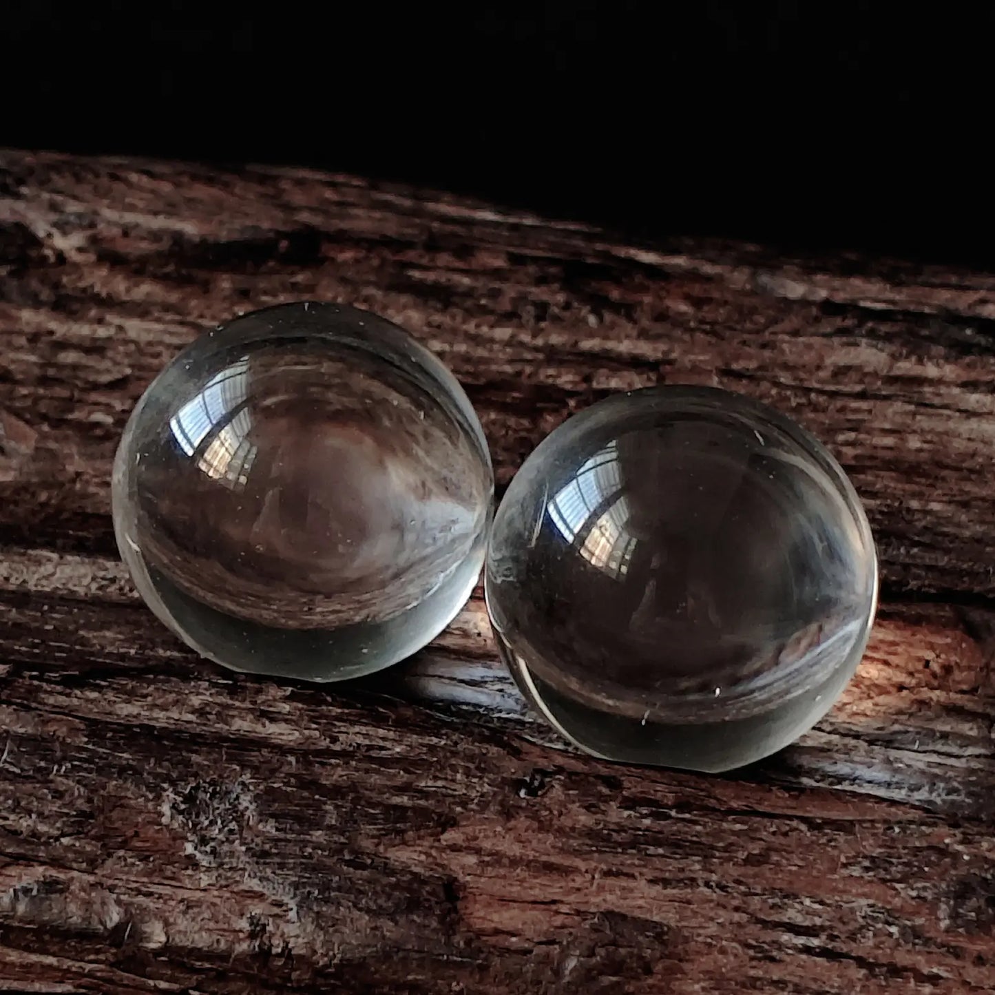 Two natural clear quartz spheres (approx. 2cm) on resin base, demonstrating near-inclusion-free transparency and smooth polish; minimalist spiritual decor