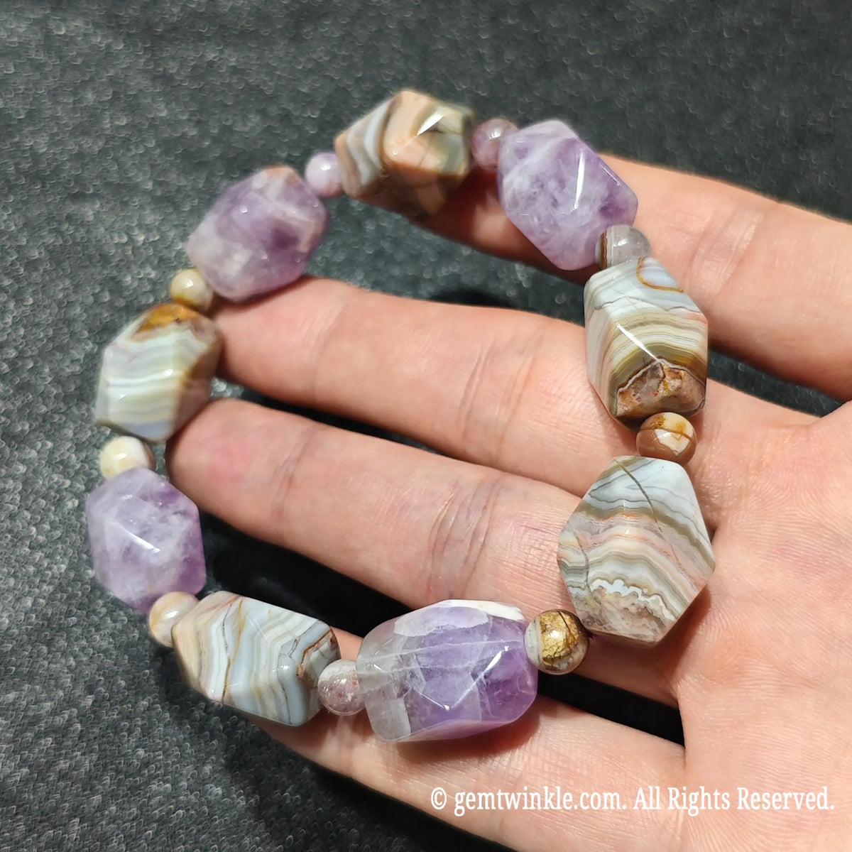 Side view of a natural amethyst and banded agate faceted nugget stretch bracelet showing earthy mineral stripes