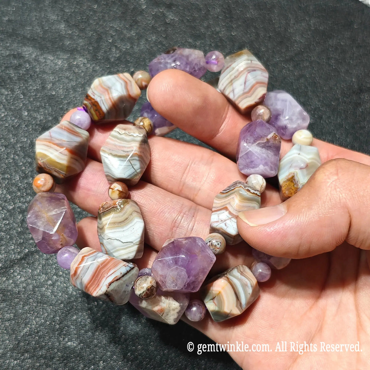 Close up view of stacked amethyst and banded agate faceted nugget bracelets highlighting unique striped agate textures