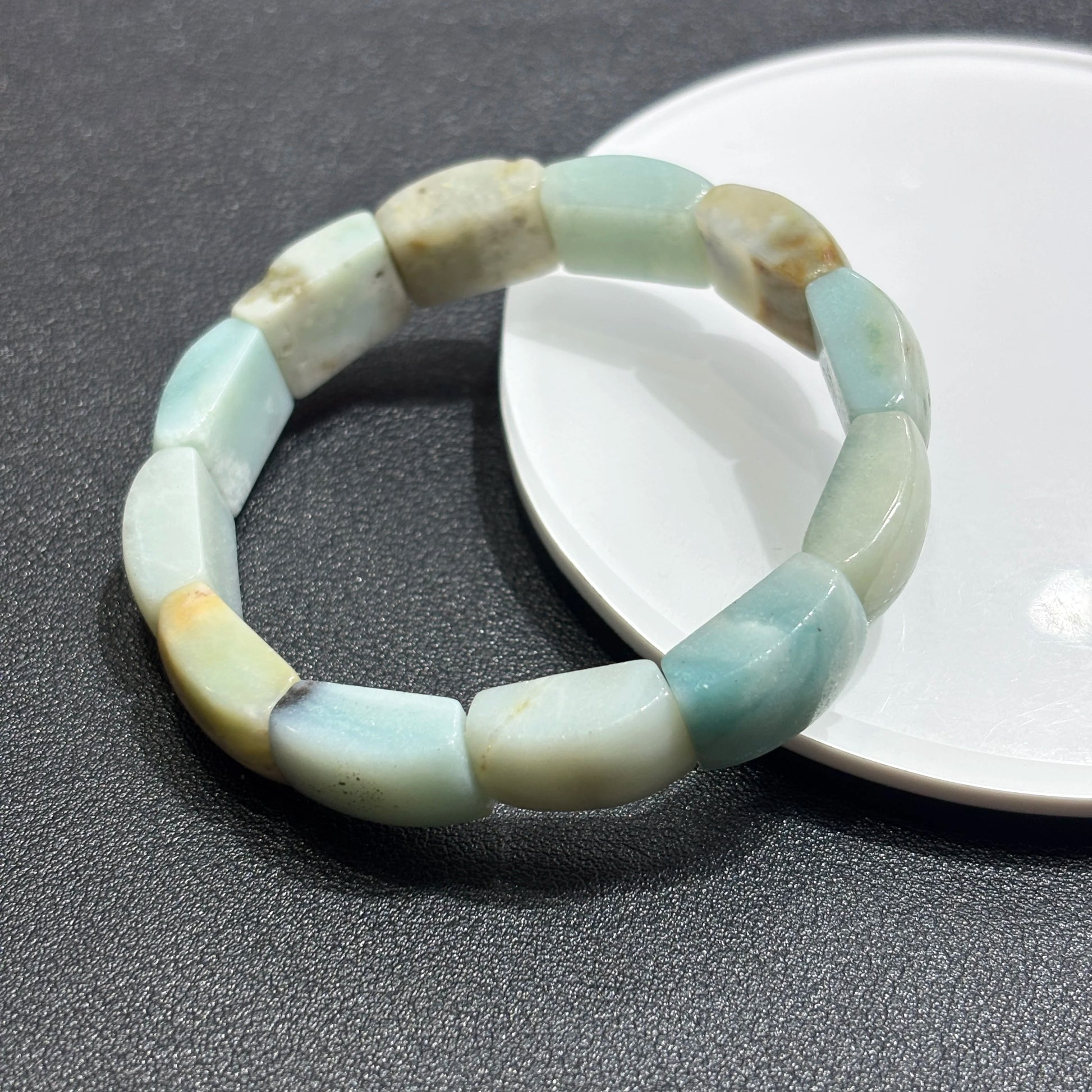 Close-up of natural caribbean calcite square slab bead; smooth edges, semi-translucent quality, and subtle color zoning