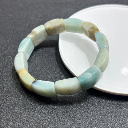 Close-up of natural caribbean calcite square slab bead; smooth edges, semi-translucent quality, and subtle color zoning