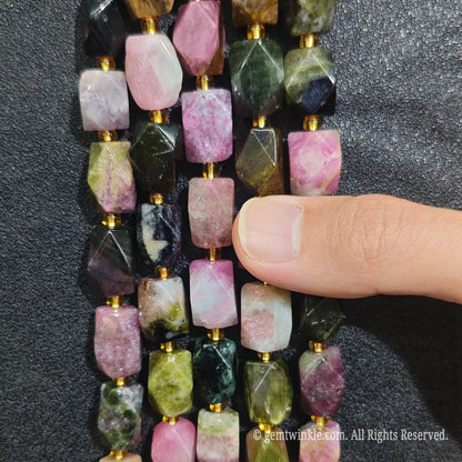 Close up view of natural multi tourmaline faceted block beads highlighting light reflecting facets and polished colorful luster