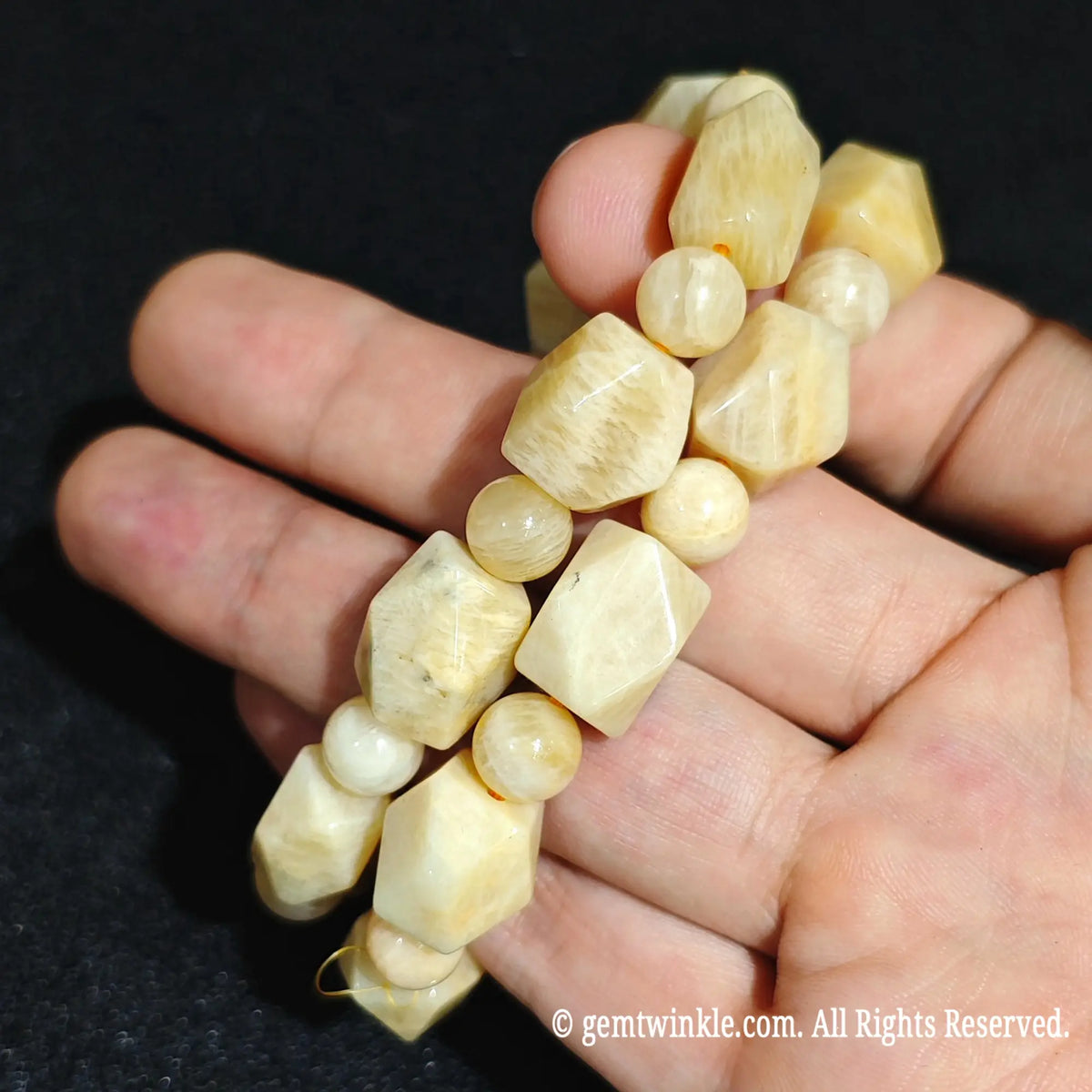 Close up view of stacked golden yellow quartzite faceted bracelets showcasing natural mineral grains and butterscotch colors