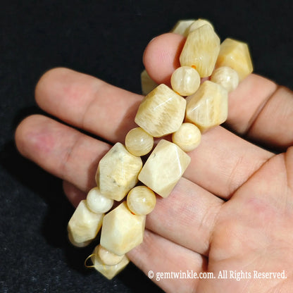 Close up view of stacked golden yellow quartzite faceted bracelets showcasing natural mineral grains and butterscotch colors