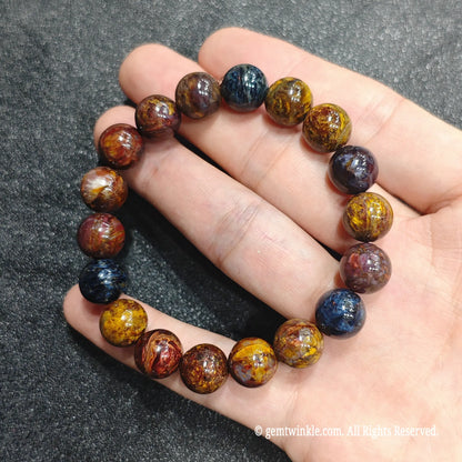Close up perspective of earthy swirl pietersite gemstone beads showing brecciated quartz textures