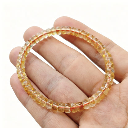 Mini citrine tablet bracelet gently flexed to demonstrate elasticity and uniform bead alignment
