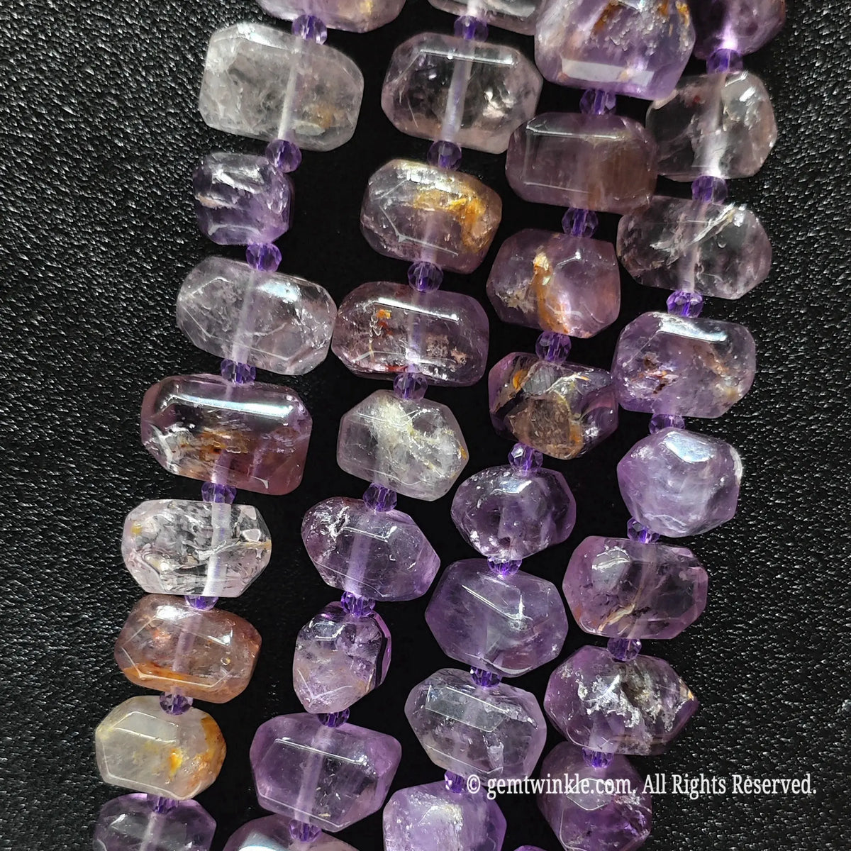 Side view of natural lavender amethyst phantom quartz pebble beads strung on loose strands