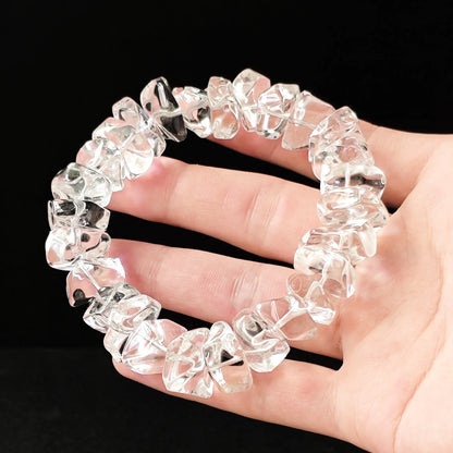 Full-circle view of genuine clear crystal bracelet held in palm; each bead uniquely shaped—no two identical, embodying authentic raw energy flow