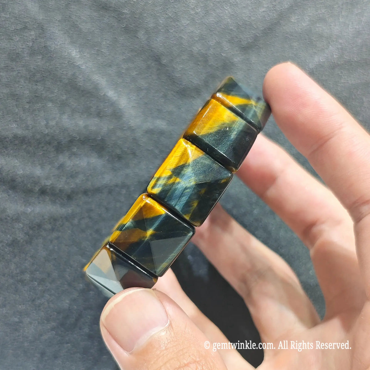 To maintain the sharp geometric facets and silky sheen of your pyramid cut tiger eye cuff, store it in a velvet pouch away from other jewelry to prevent surface scratching. Wipe down the faceted quartz edges gently using a warm, soft micro-fiber cloth after daily wear. Avoid exposing your gemstone wristband to heavy impacts or harsh industrial chemicals.