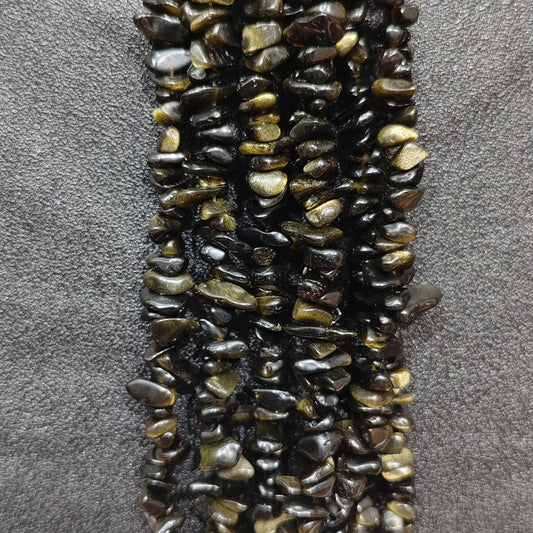 Close up of multi strands of natural golden obsidian 5-10mm irregular black and gold sheen chips[cite: 9]