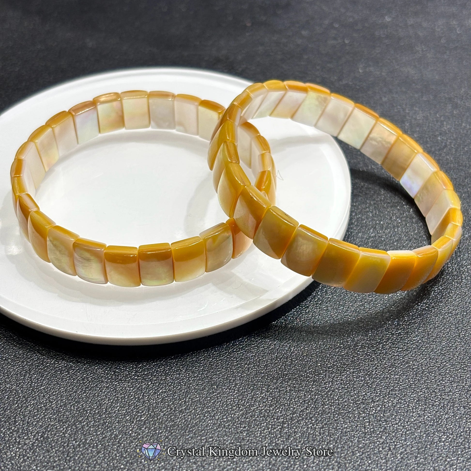 Overhead view: natural golden shell rectangle bead bangle; precise cuts, smooth edges, no elastic — a timeless rigid bangle design