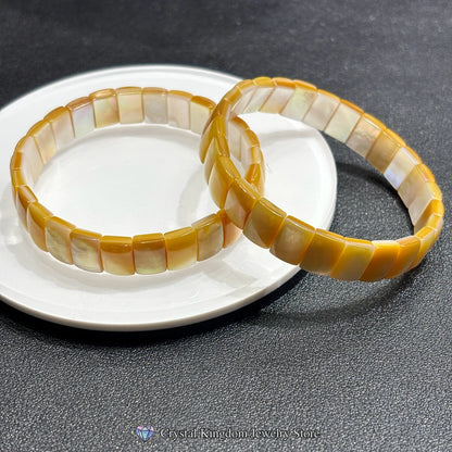 Overhead view: natural golden shell rectangle bead bangle; precise cuts, smooth edges, no elastic — a timeless rigid bangle design