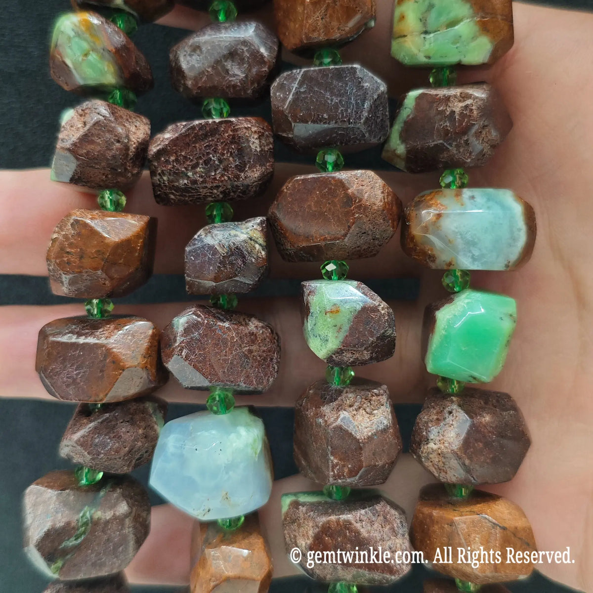 Close up view of natural green jasper faceted nugget beads highlighting bright apple green pockets and brown matrix