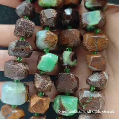 Close up perspective of multiple natural green jasper matrix cut nugget bead strands showing smooth polished finish