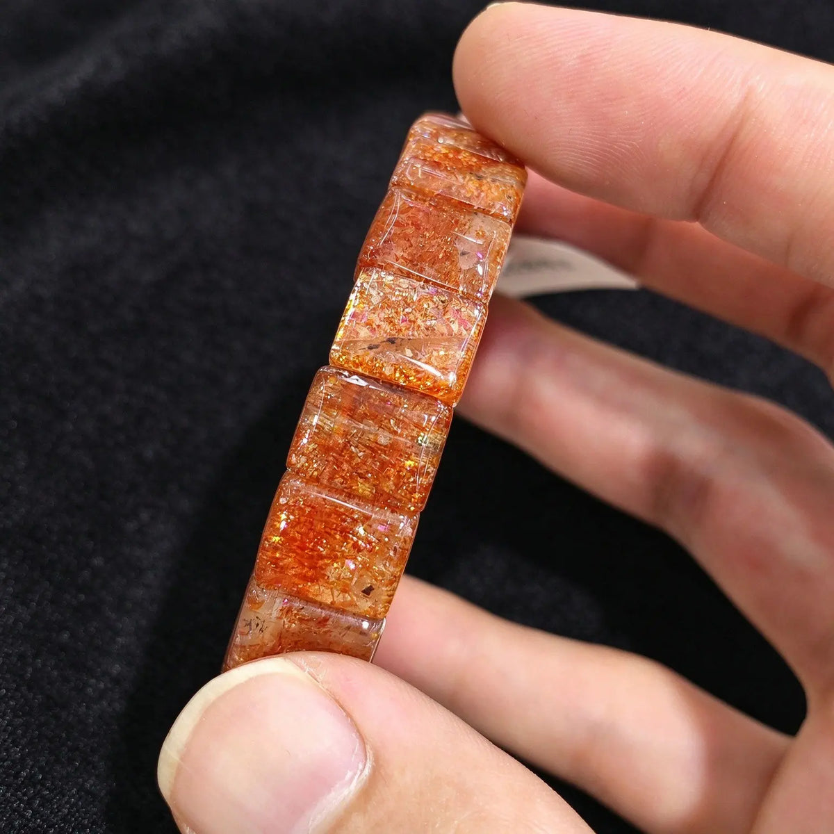 Side view of a high grade golden sunstone smooth block tile stretch bracelet displaying vitreous polish and double row elastic construction