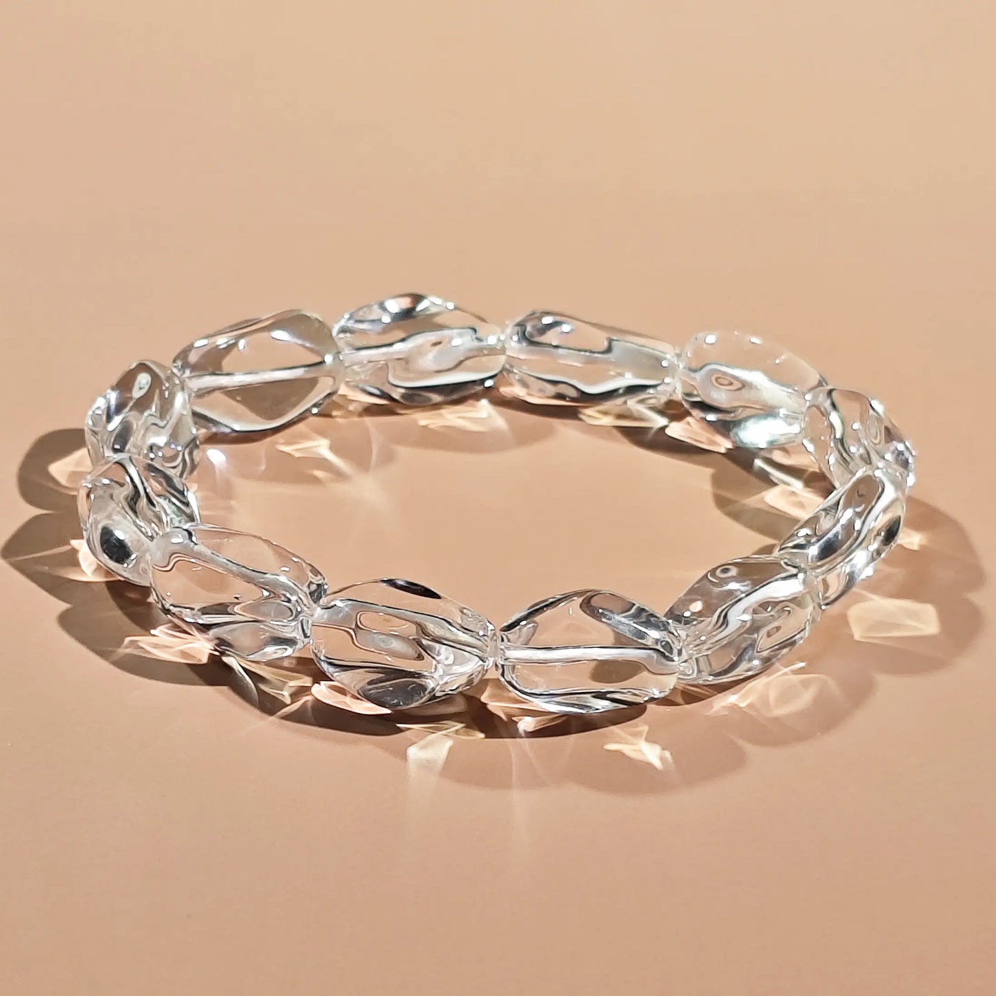 Clear quartz beads in natural irregular shapes—high transparency with minimal internal inclusions, strung on elastic cord