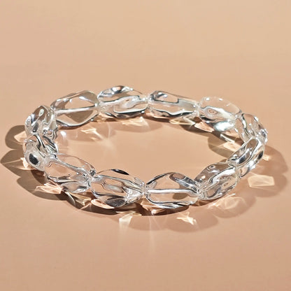 Clear quartz beads in natural irregular shapes—high transparency with minimal internal inclusions, strung on elastic cord