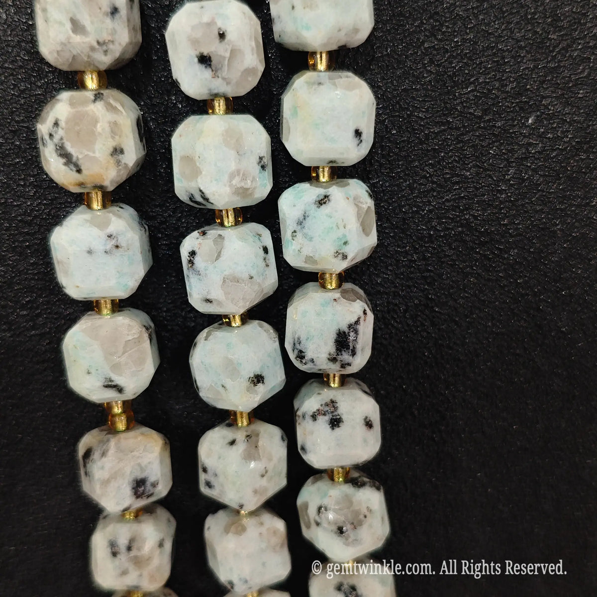 Fingers holding natural kiwi jasper soft square gemstone block beads to show scale and proportion