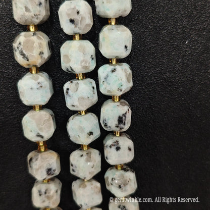 Fingers holding natural kiwi jasper soft square gemstone block beads to show scale and proportion