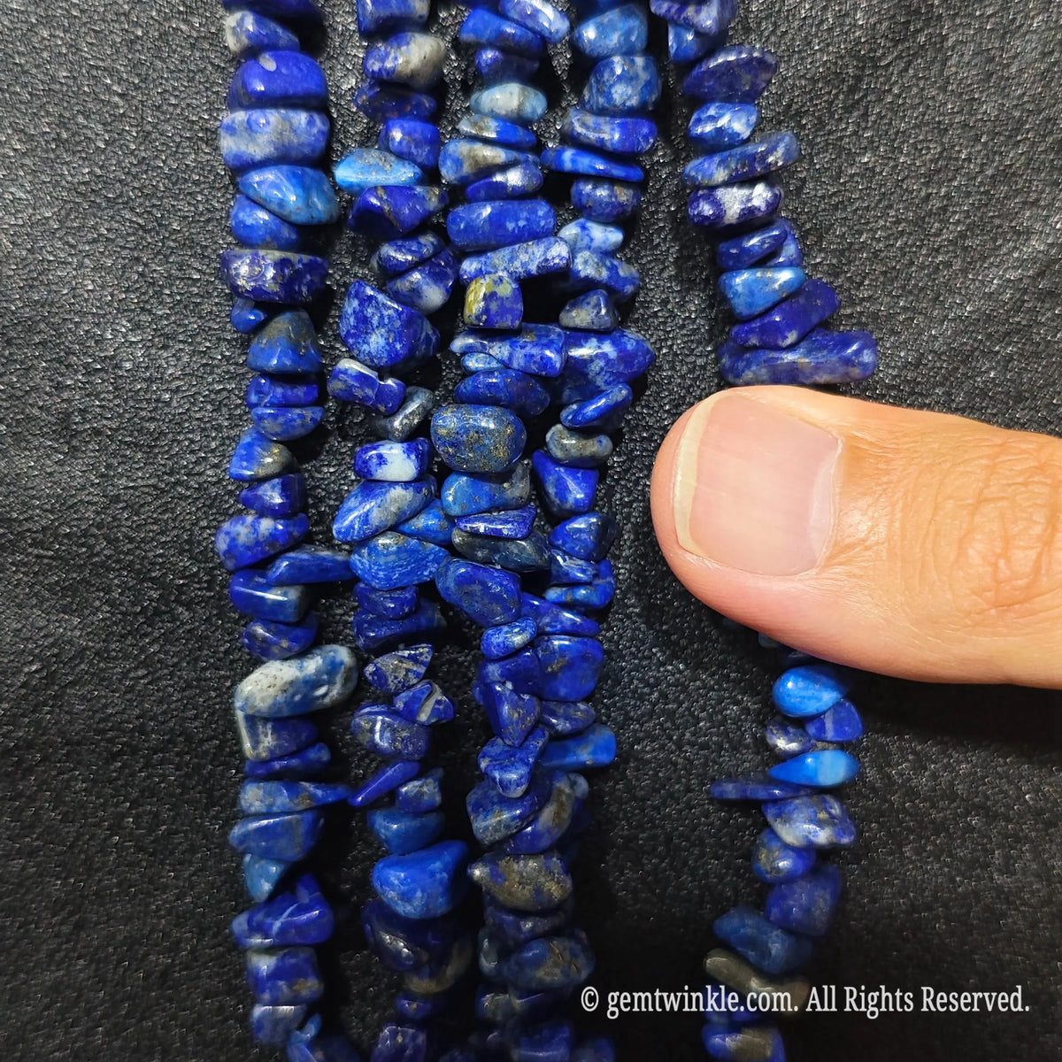 Detailed view of long 75cm natural lapis lazuli chipped strand ready for wholesale DIY projects