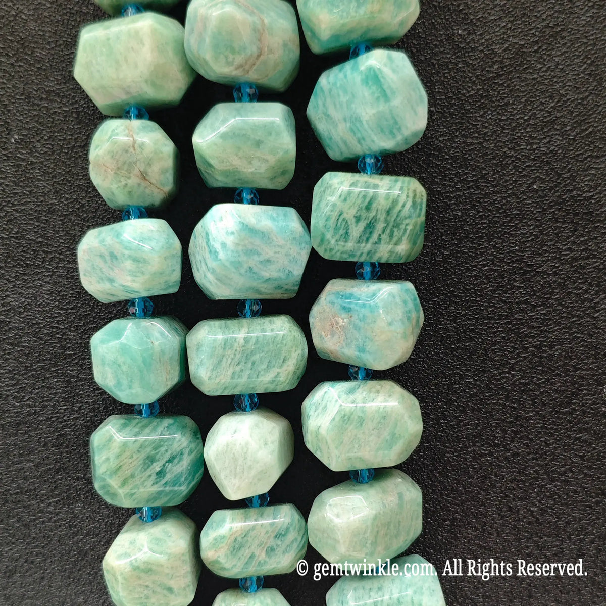 Close up view of natural mint green amazonite freeform faceted nugget beads highlighting unique facets and white grid patterns