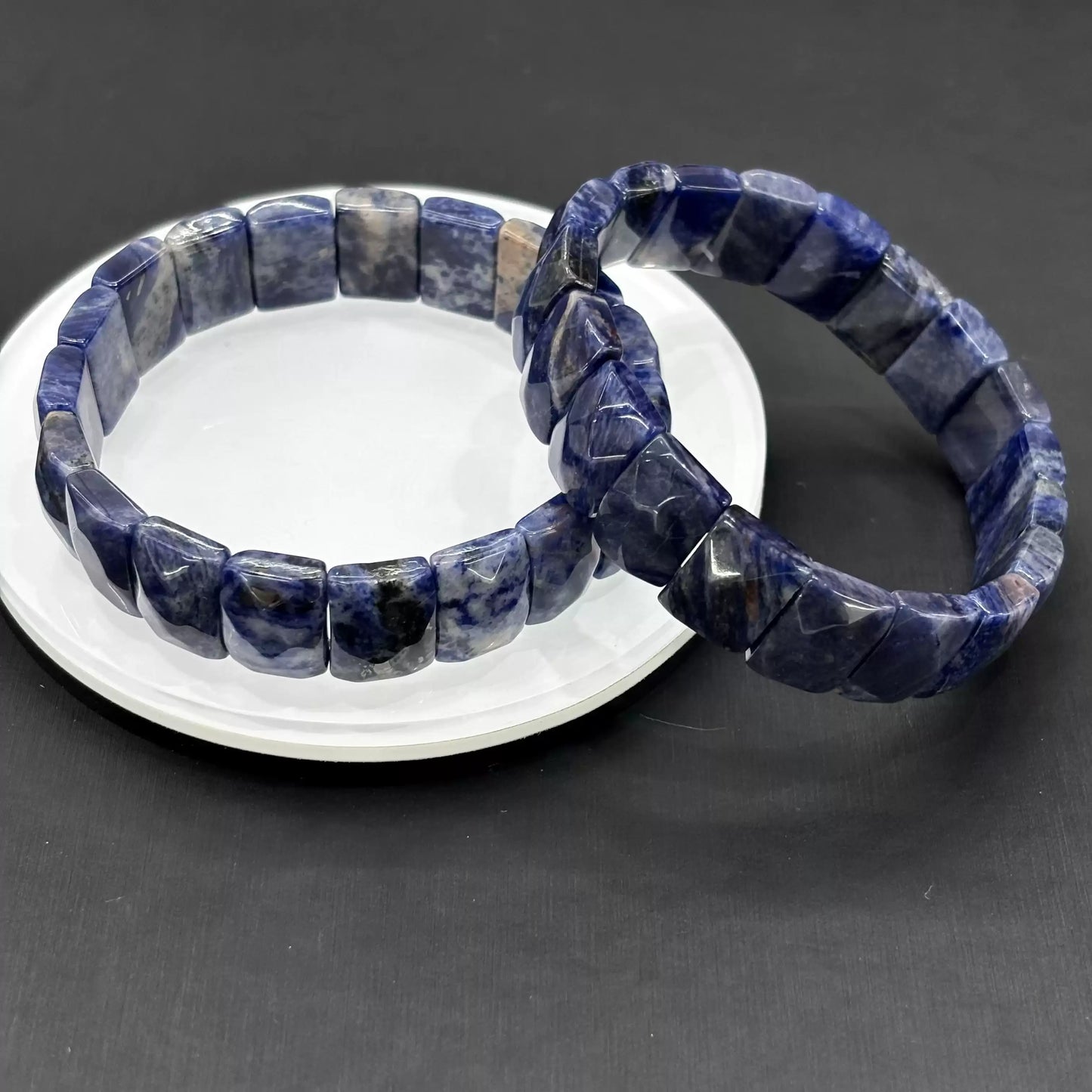 Two natural sodalite bracelets styled together—showcasing the unique white matrix patterns in each bead