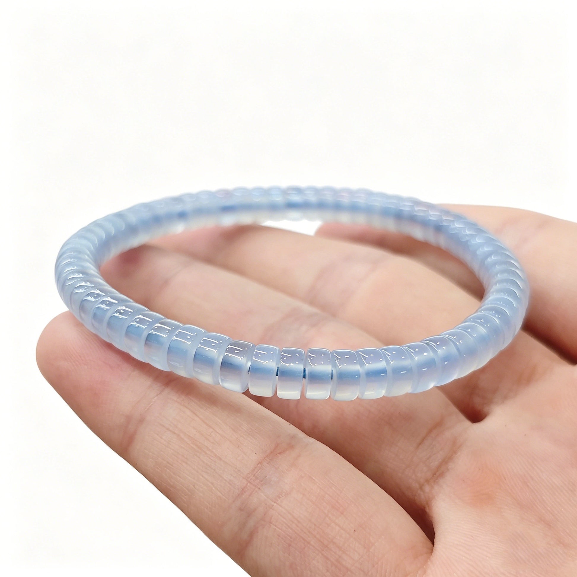 Blue agate tablet bracelet resting on palm—highlighting delicate size, soft sky-blue hue, and natural banding